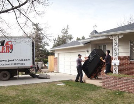 Workers removing old appliance from an apartment in Boise, ID.