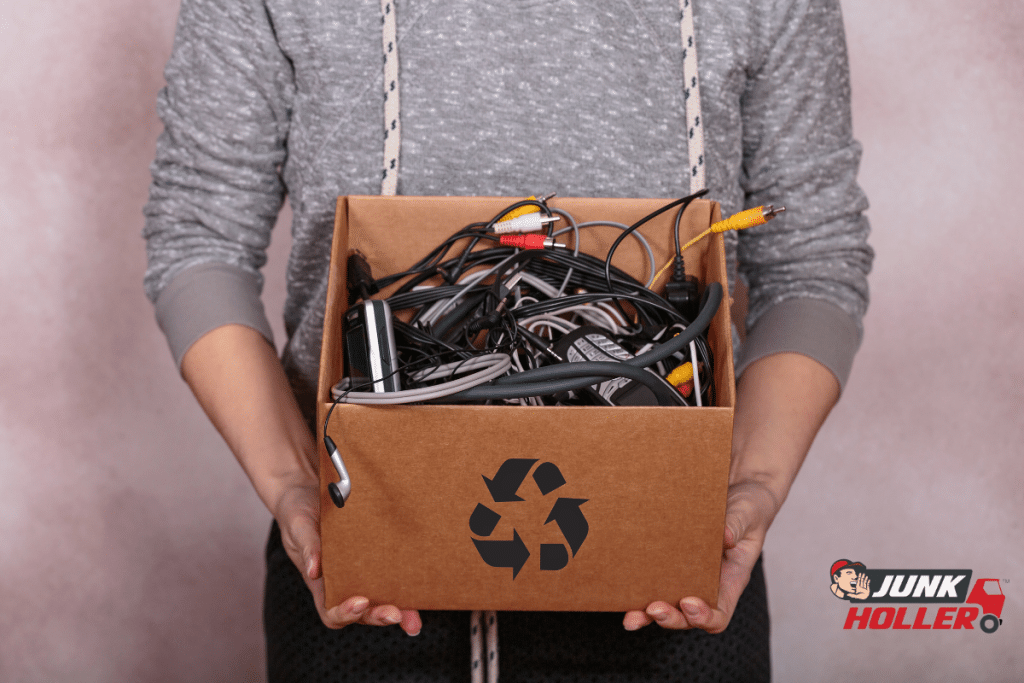 A woman holding a box of old electronics to be recycled in Boise, Idaho.