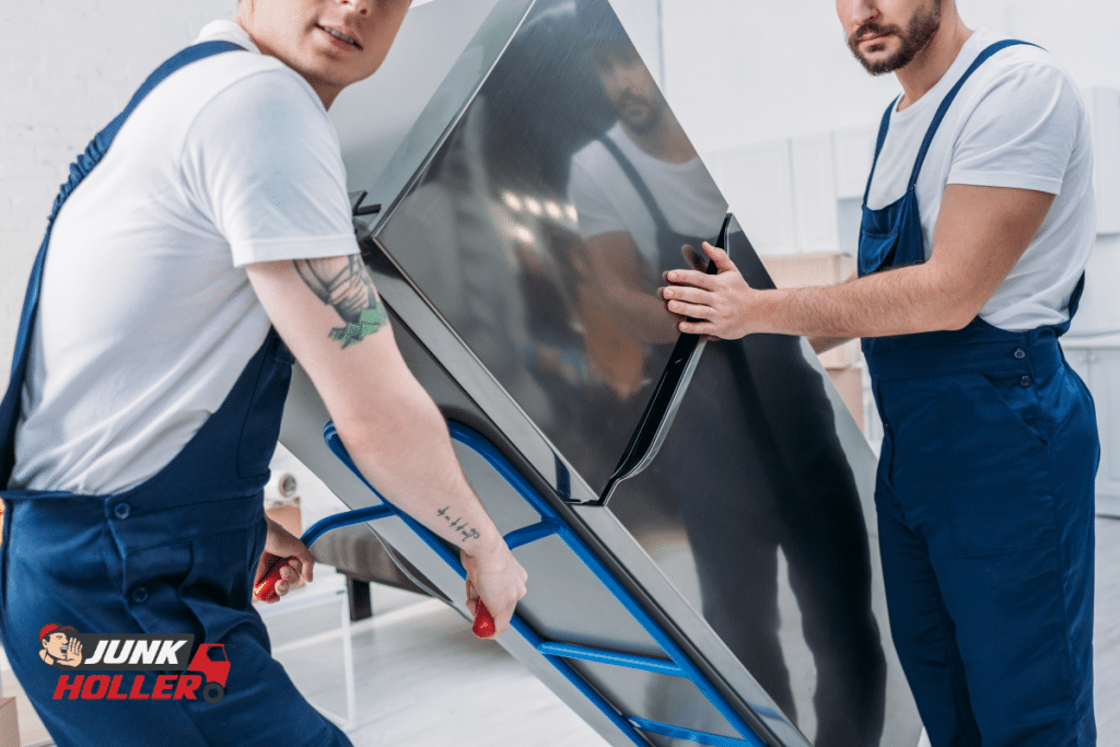 A fridge being removed by two workers in Boise, Idaho.